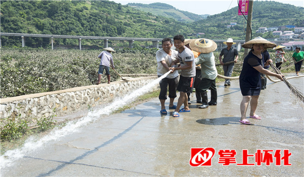 7月3日,溆浦县大江口镇清江屯村村民正在清洗马路,积极开展灾后重建