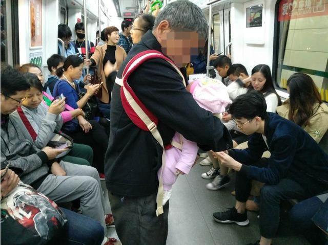 南宁60岁老人抱婴儿乘坐地铁 车里年轻人低头玩手机无