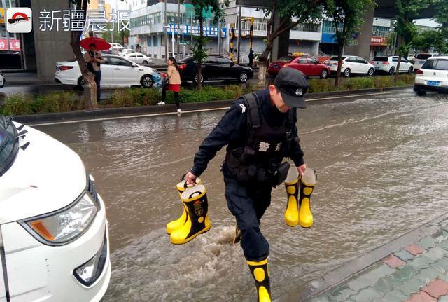 乌市阿勒泰路辅道积水漫延,民警雨中守候为市民提供雨靴