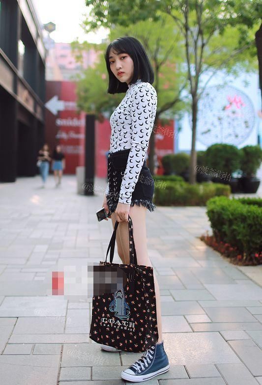 街拍:美女穿毛边牛仔短裤展露皙白大长腿,这是