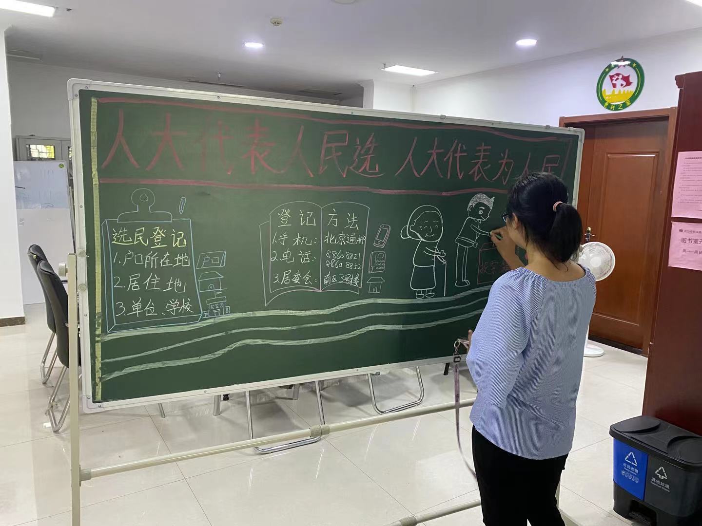 选好代表为人民"的横幅醒目悬挂在选民登记站上方,宣传员书写的黑板报