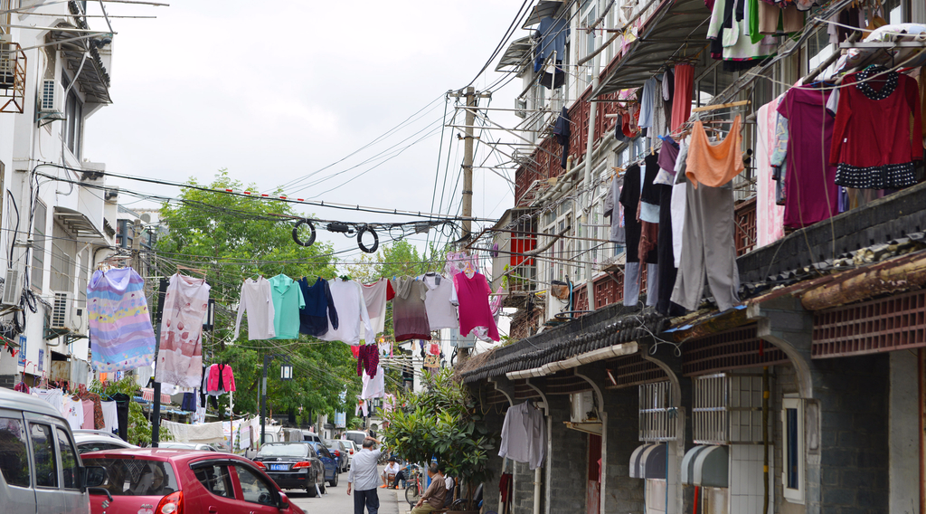 糖坊廊古街是城中村，这些老宅子三层高而且周围空间比较拥挤。图为居民晾晒在电线及变压器附近的衣物。