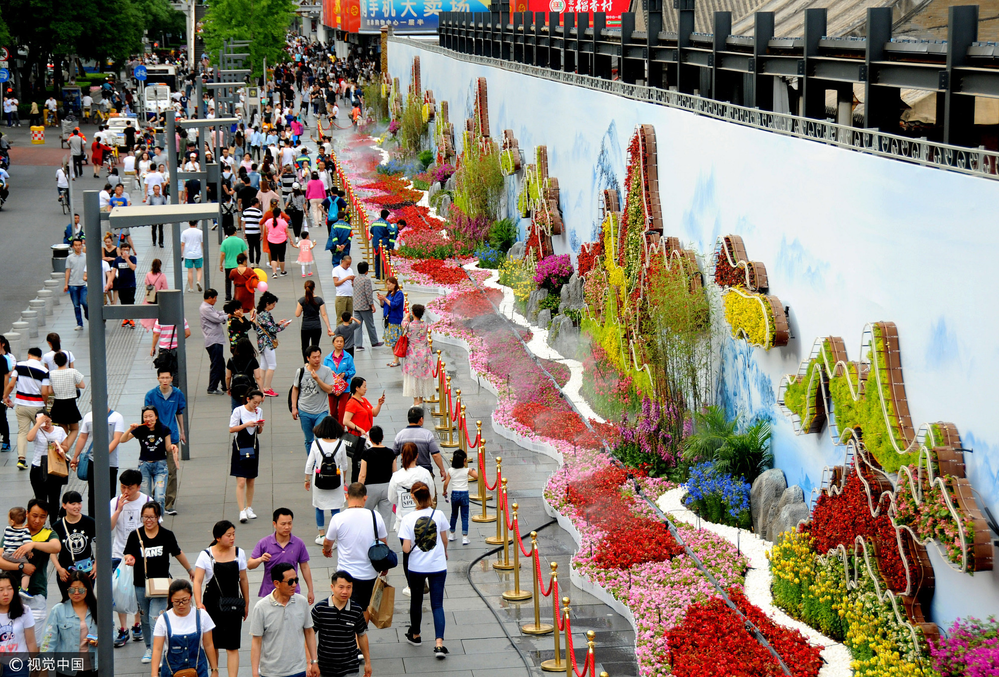 2017年5月14日,北京天高云淡,在西单街头,一组运用垂直绿化系统结合时令花卉的立体工艺植物生态墙完工亮相,庆贺“一带一路”高峰论坛召开。