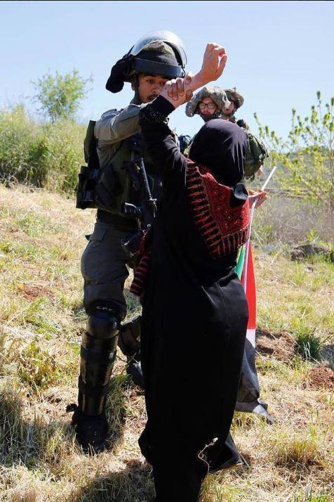 图为扬娜拍摄的一名以色列士兵正在殴打巴勒斯坦妇女.