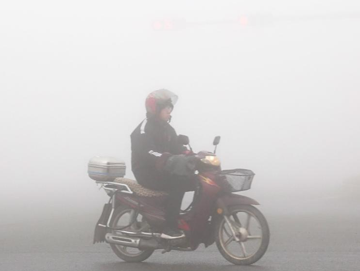 11月26日，大连市气象台先后发布了霾黄色预警和大雾橙色预警信号。图为雾霾笼罩下的大连金普新区街头。